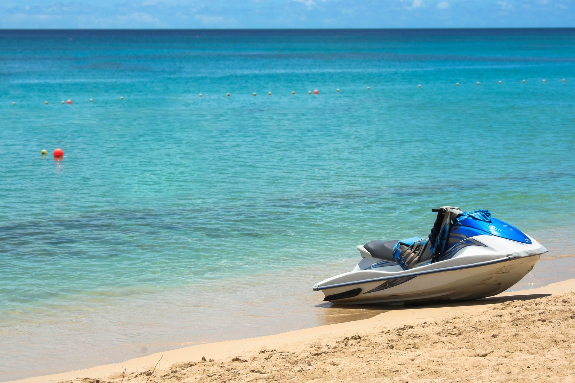 Blue jet ski on sand at beach